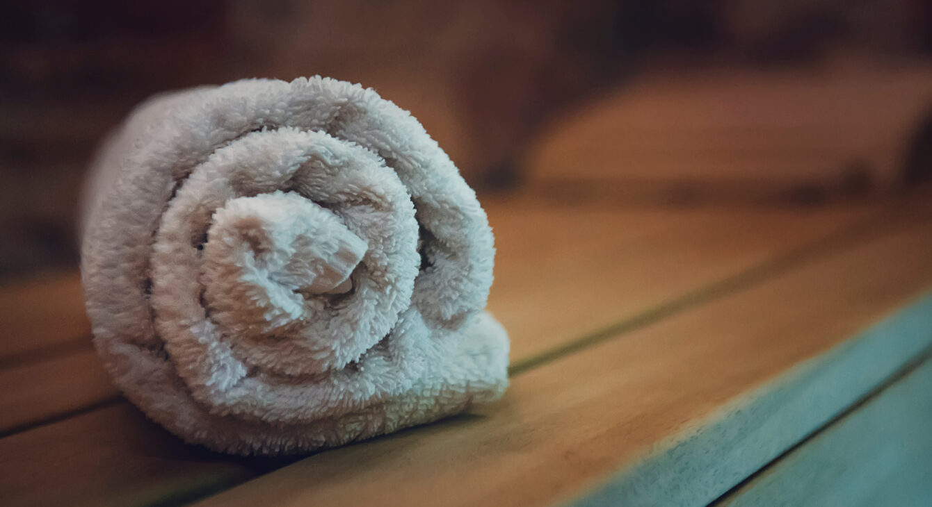 Traditional wooden sauna for relaxation with a set of clean towels. Good quality service in a classical steam sauna. First-class amenities of an eco-designed sauna. A towel put for using in sauna